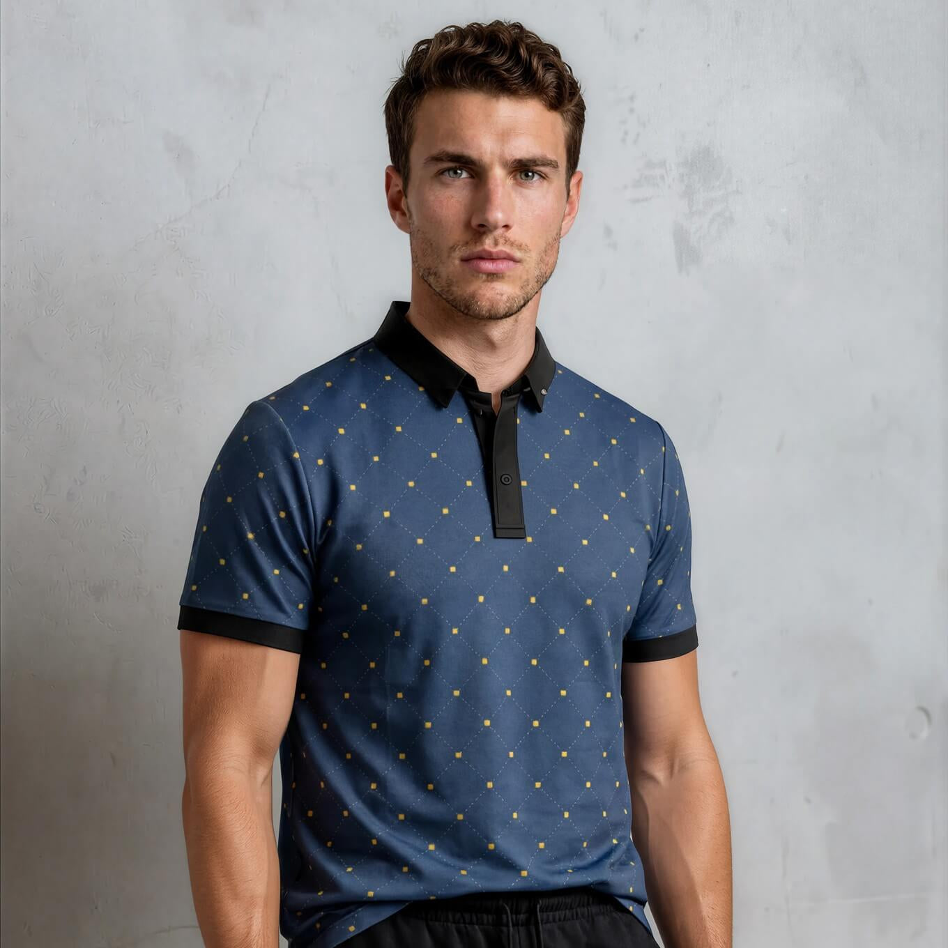 Man wearing a blue polo shirt with black accents and black shorts against a gray background