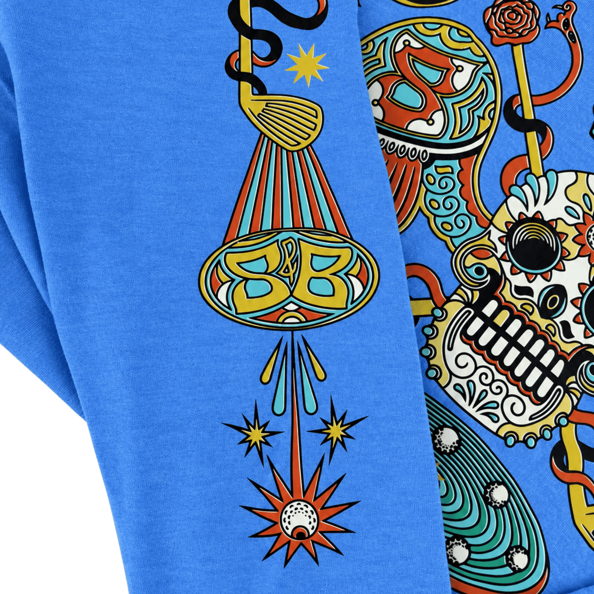 Close-up of a bright blue graphic sweatshirt featuring a colorful Day of the Dead style print with a skull, snake, and decorative motifs.