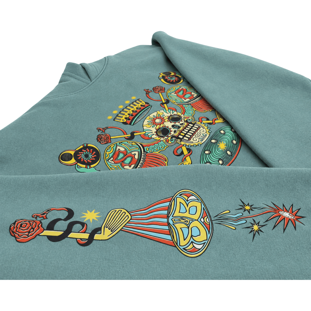 An Arctic Blue Skull & Bogeys hoodie featuring a large, colorful graphic print on the front. The design is highly detailed and multicolored, containing elements like a skull, a horn, a snake, a rose, and stars, set against a clean white background.