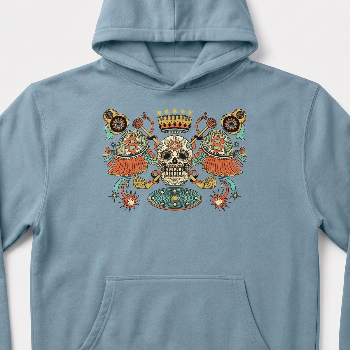 A light blue pullover hoodie with a colorful Day of the Dead sugar skull graphic on the chest, displayed against a light gray background.