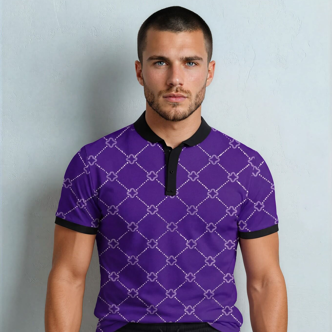 Man wearing a purple patterned shirt with black accents against a light gray background