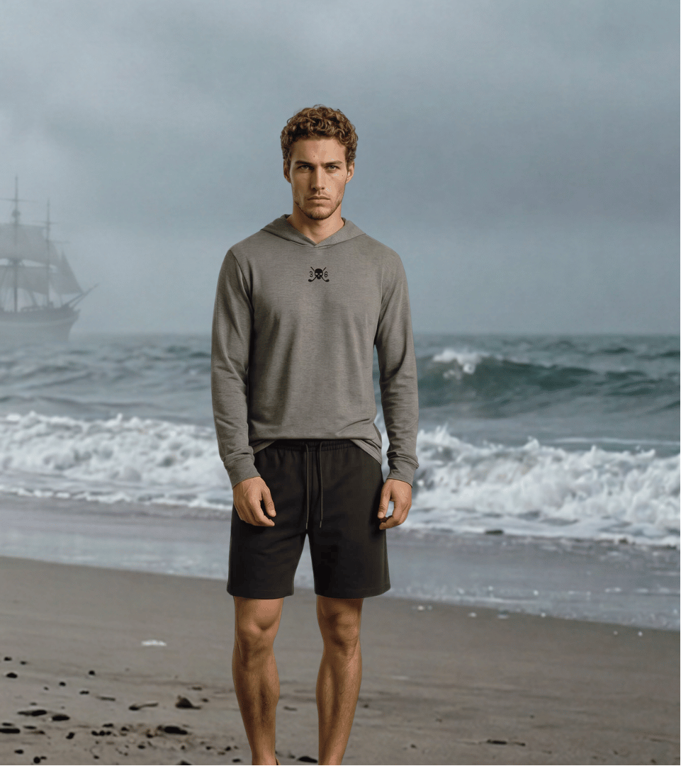 Two people standing on a beach with a ship in the background