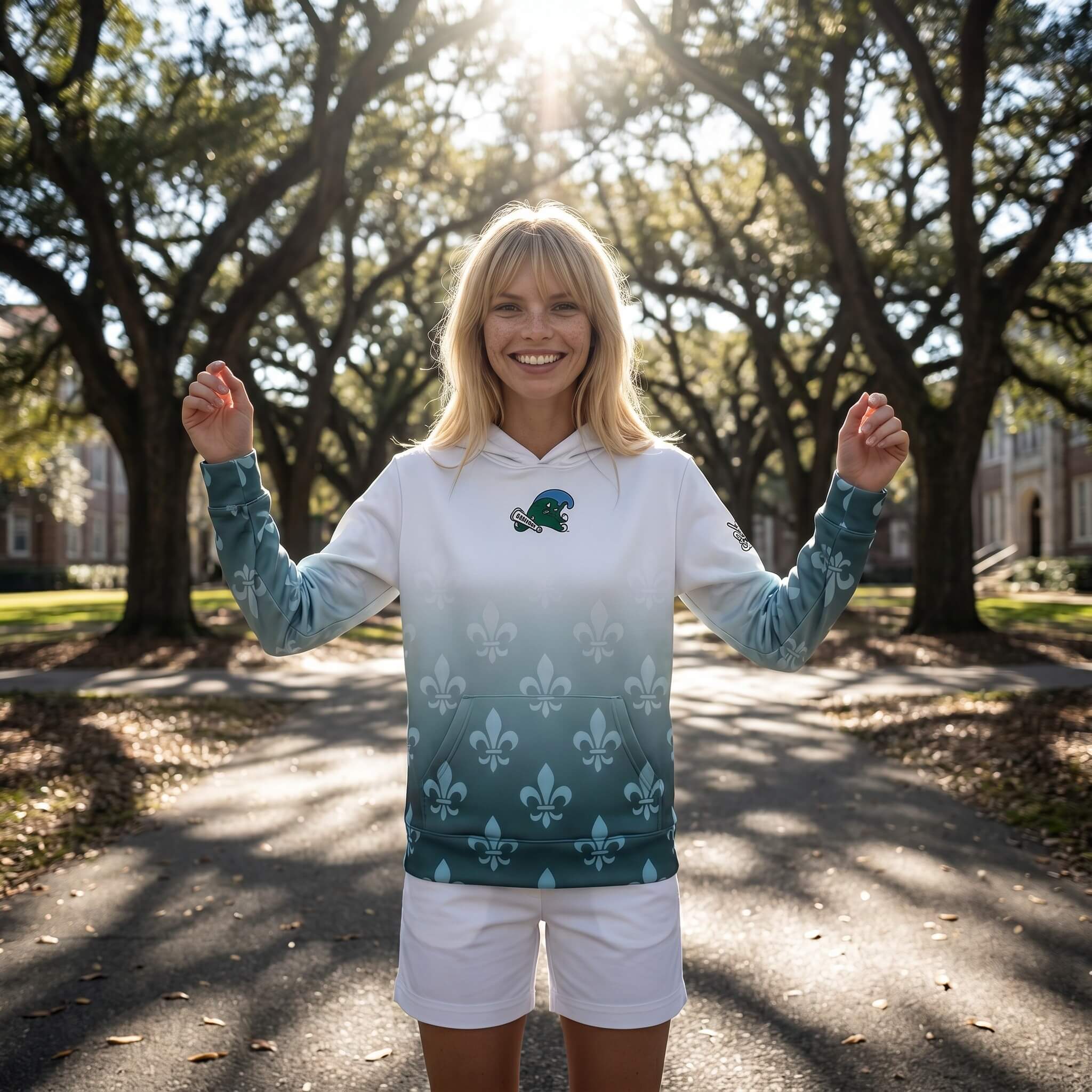 Woman wearing a hoodie with a logo in an outdoor setting