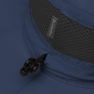 Close-up of a blue Columbia hat with a brand logo on a dark background