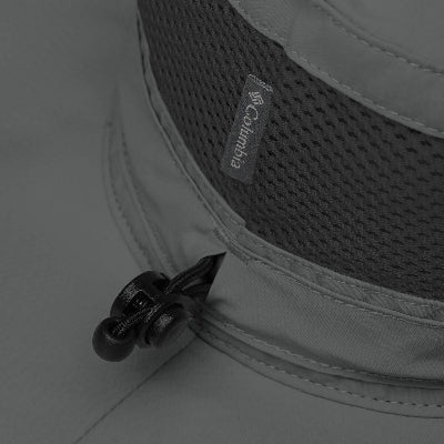 Close-up of Columbia logo on a gray jacket with a zipper detail.