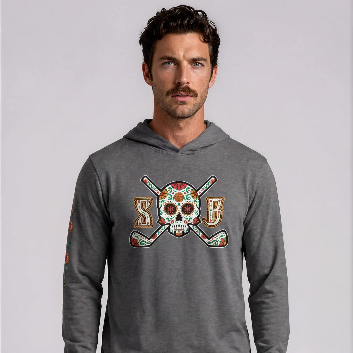 Man wearing a gray hoodie with a colorful graphic design on a light gray background