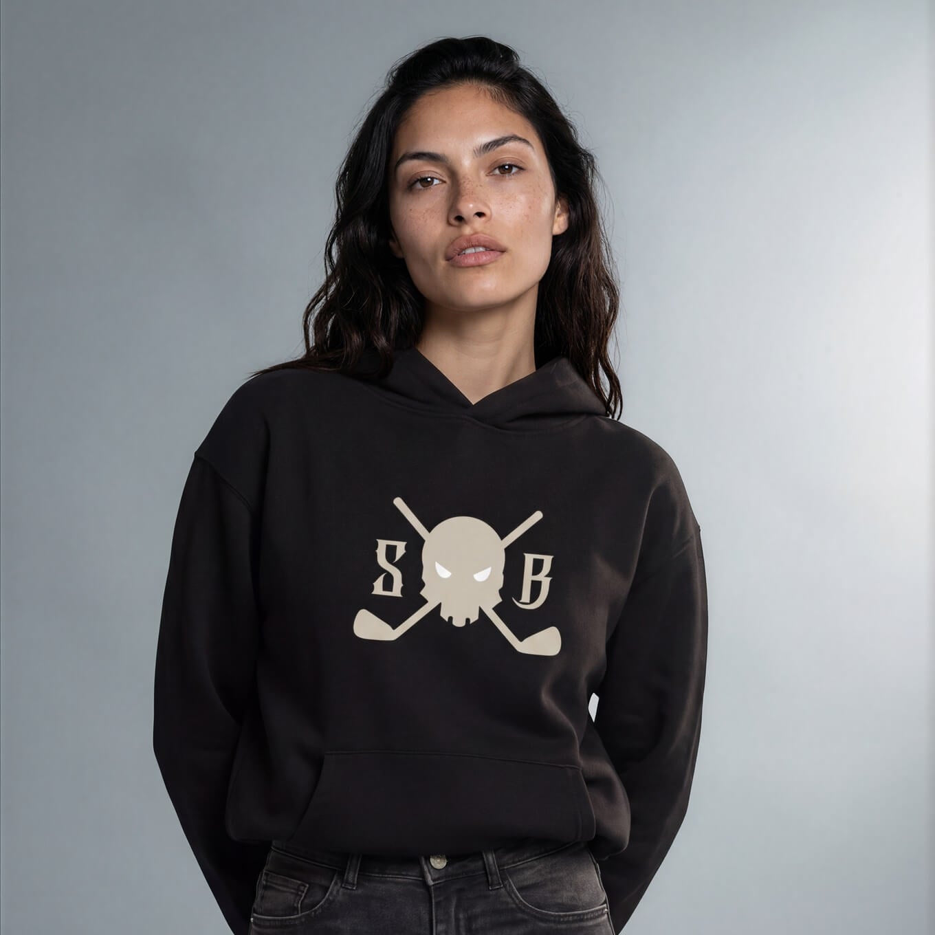 Person wearing a black hoodie with a white logo on a gray background