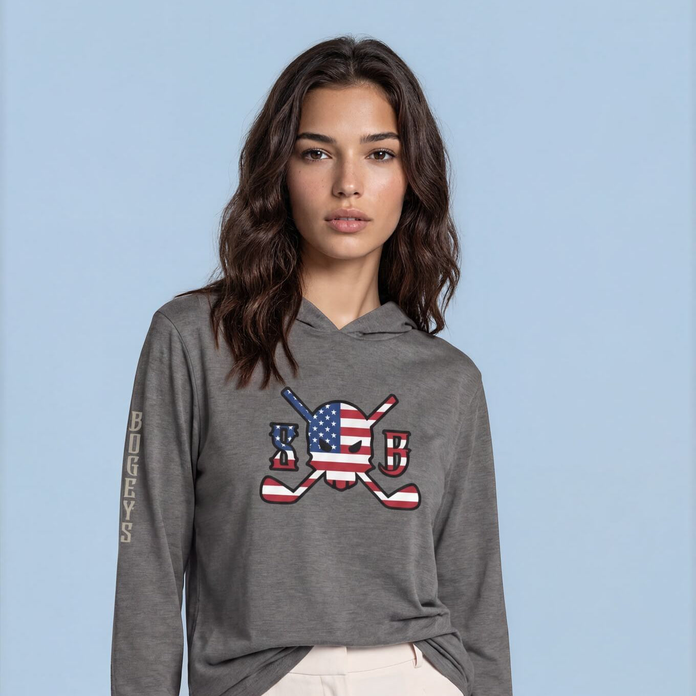 Woman wearing a gray hoodie with a graphic design on a blue background