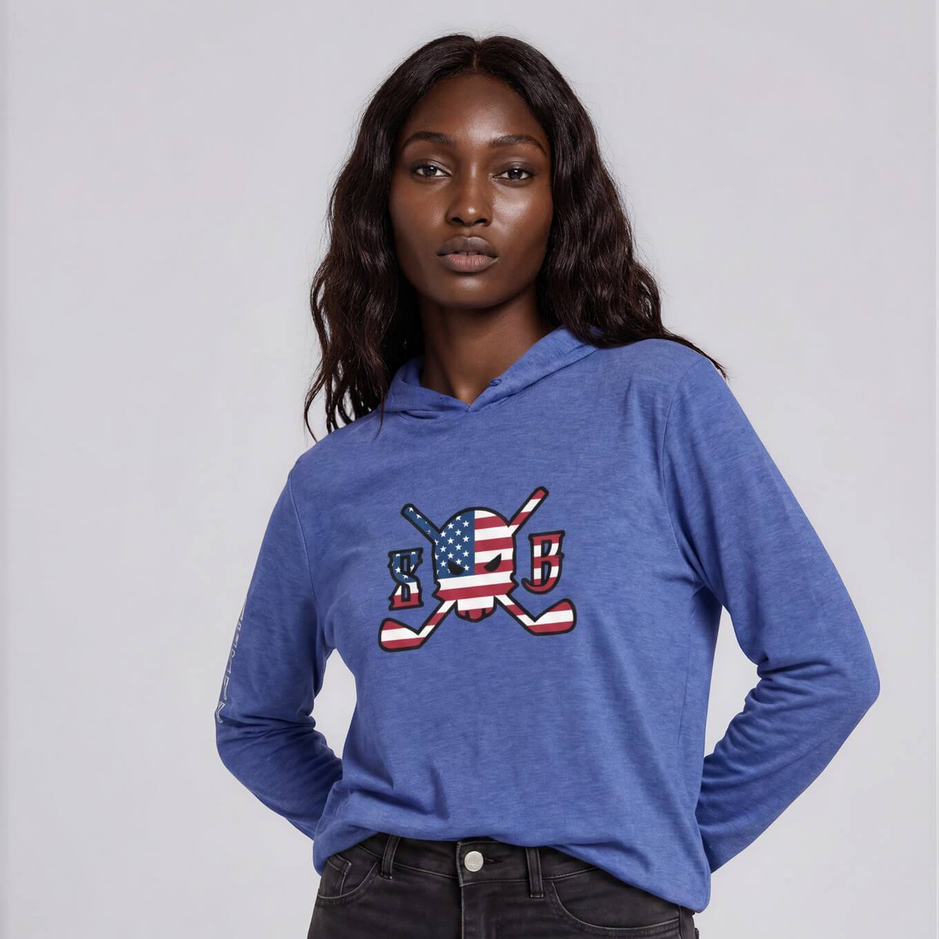 Person wearing a blue hoodie with an American flag design on a plain background